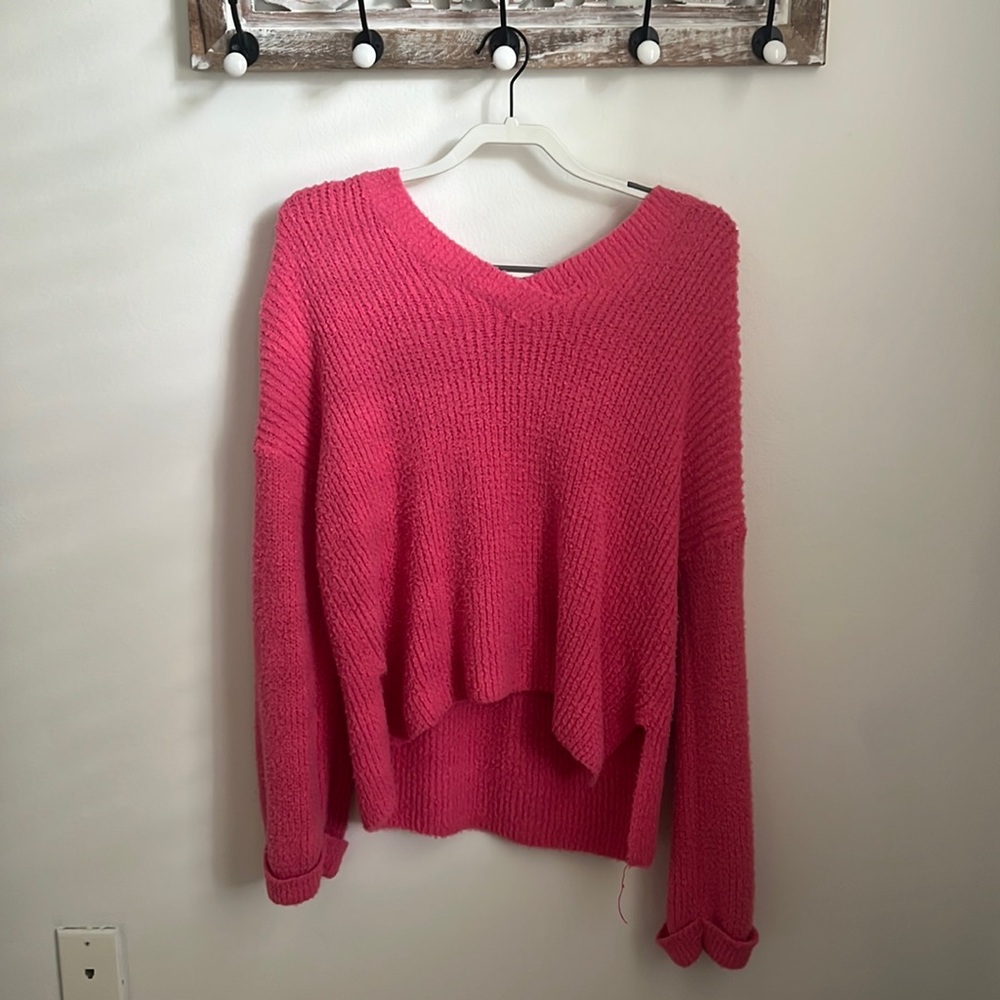 This is an altard state extra small v-neck pink sweater.